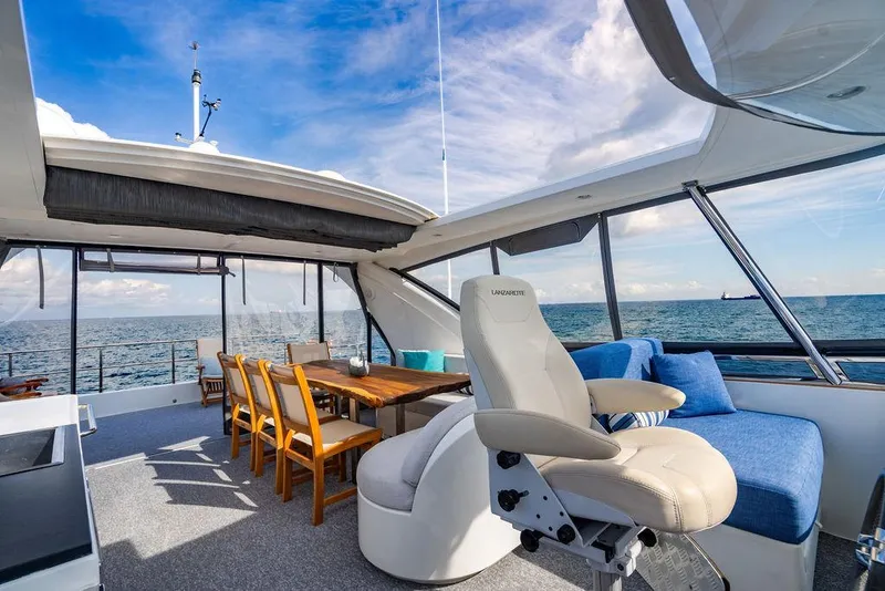 Slide: The Image of Luxurious 2013 Custom 73 Lanzarote yacht interior with ocean view, featuring seating and dining area. - 40