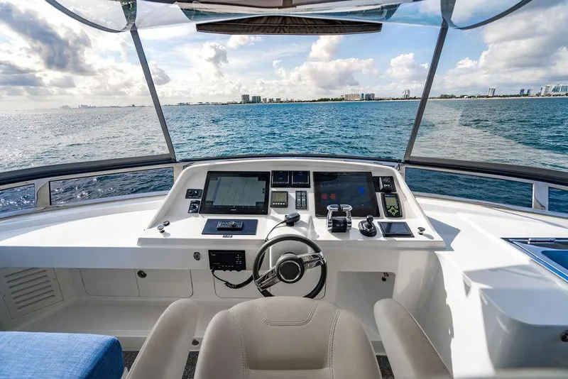 Slide: The Image of Cockpit view of 2013 Custom 73 Lanzarote yacht, featuring modern navigation equipment and ocean scenery. - 46