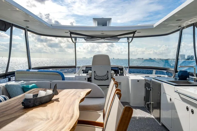 Slide: The Image of Luxurious yacht interior with ocean view, featuring a wooden table and modern amenities. - 51