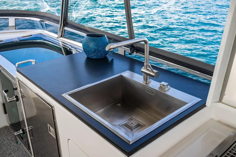 Slide: The Image of Luxury yacht kitchen sink with ocean view, featuring modern stainless steel design. - 55