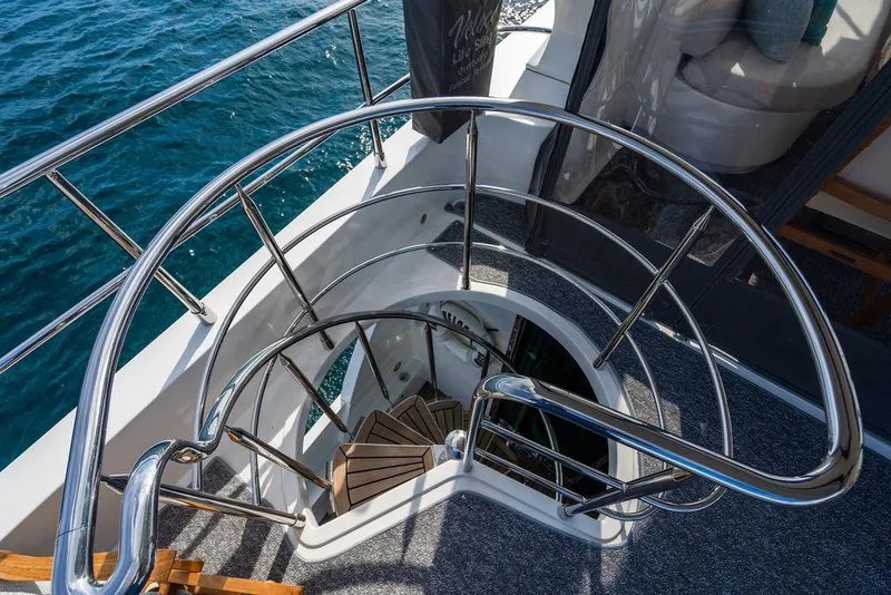 Slide: The Image of Spiral staircase on 2013 Custom 73 Lanzarote yacht, overlooking blue ocean waters. - 57