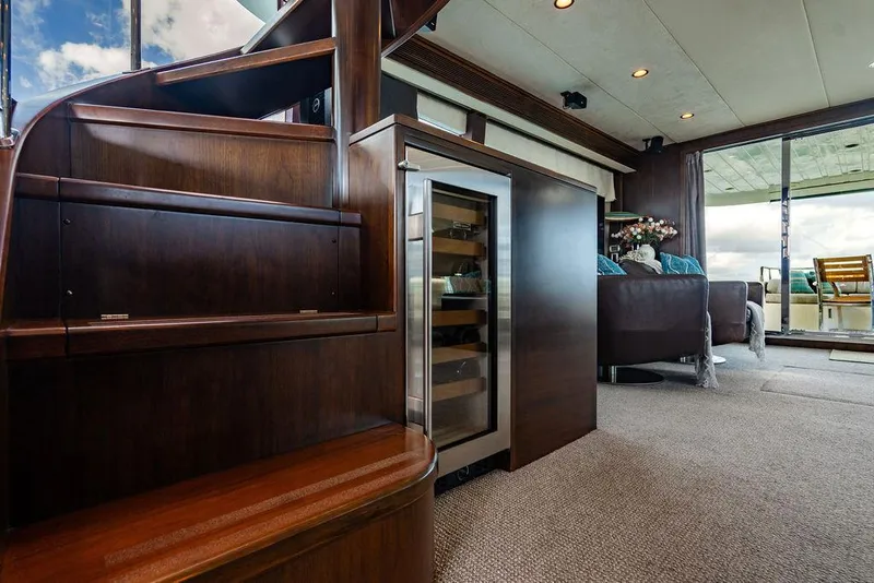 Slide: The Image of Luxurious yacht interior with wooden staircase, wine cooler, and cozy seating area. - 63