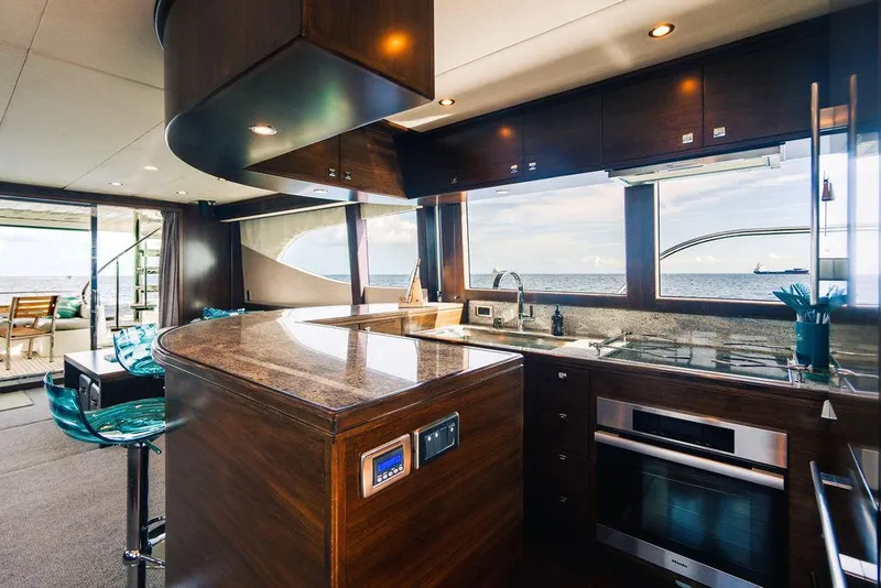 Slide: The Image of Luxurious yacht kitchen interior with ocean view, featuring modern appliances and sleek wooden finishes. - 66