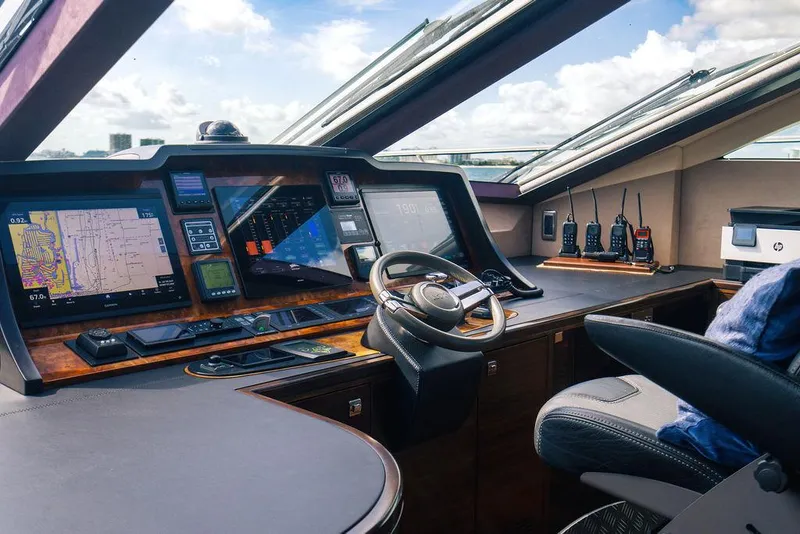 Slide: The Image of Cockpit of 2013 Custom 73 Lanzarote yacht with navigation screens and steering wheel. - 73