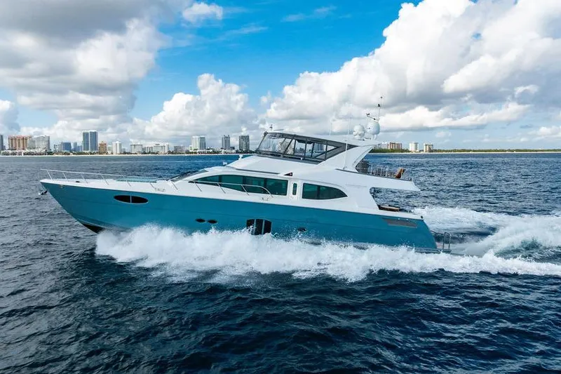 Slide: The Image of Custom 73 Lanzarote yacht cruising on ocean, 2013 model, with city skyline in background. - 8