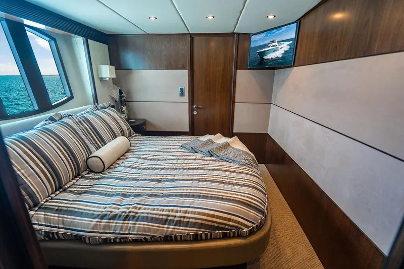 Slide: The Image of Luxurious bedroom on 2013 Custom 73 Lanzarote yacht with ocean view and striped bedding. - 96
