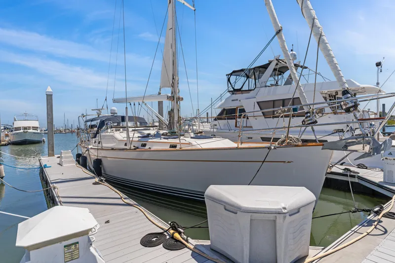The Image of Docked sailboat, Pasport 51 model, 2009, in a marina under clear blue skies. - 0