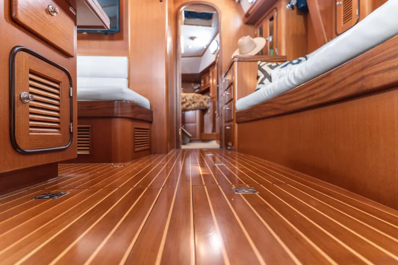 Slide: The Image of Luxurious wooden interior of a 2009 Pasport 51 yacht, featuring elegant cabinetry and seating. - 15