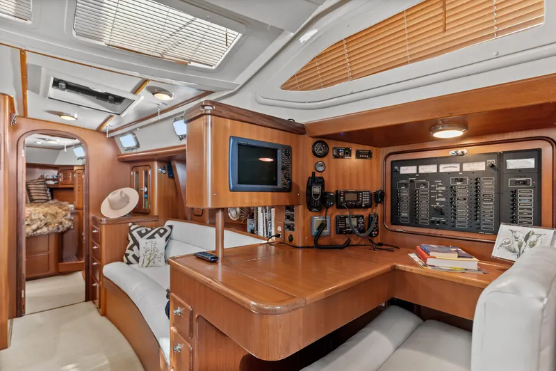 Slide: The Image of Luxurious interior of a 2009 Pasport 51 yacht with navigation equipment and cozy seating. - 21