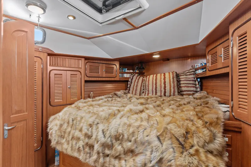 Slide: The Image of Luxurious cabin interior of 2009 Pasport 51 yacht with plush bedding and wooden cabinetry. - 24