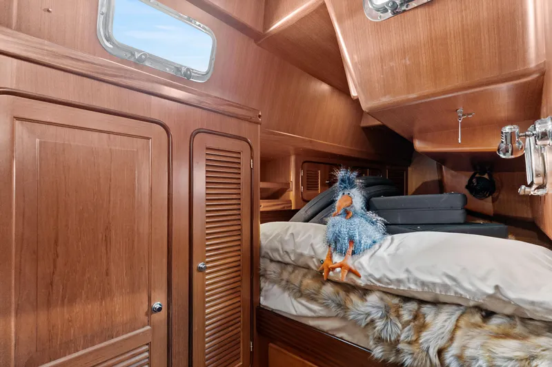 Slide: The Image of Cozy cabin interior of 2009 Pasport 51 yacht with plush toy and wooden finish. - 31