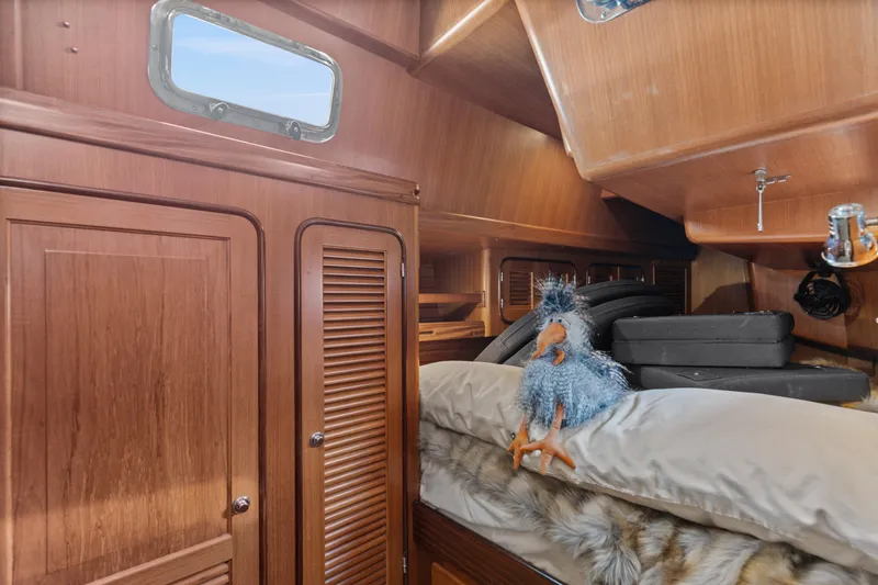 Slide: The Image of Cozy cabin interior of 2009 Pasport 51 yacht with plush bedding and stuffed toy. - 32