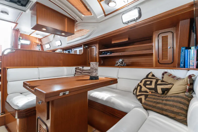Slide: The Image of Luxurious 2009 Pasport 51 yacht interior with wooden finishes and comfortable seating. - 36
