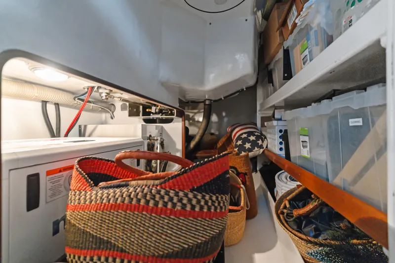 Slide: The Image of Storage area in a 2009 Pasport 51, featuring baskets and organized shelves. - 37