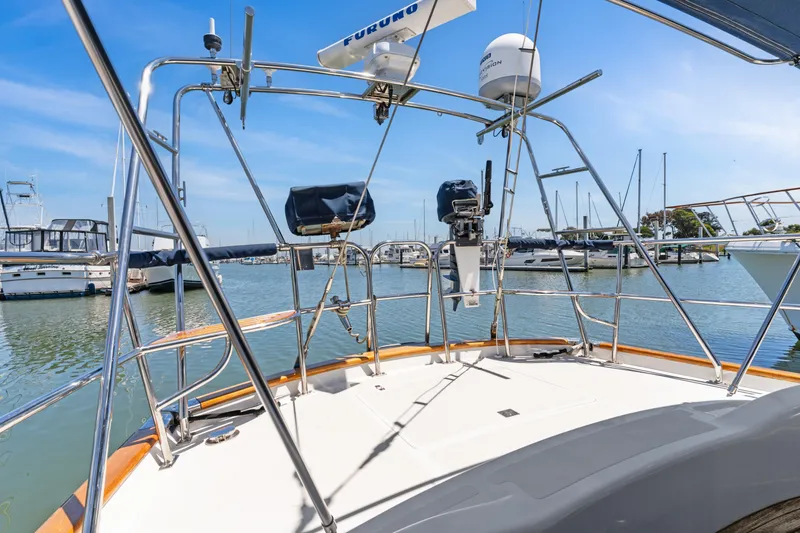 Slide: The Image of Sailboat deck view at marina, featuring Pasport 51 model, 2009, with clear blue sky. - 5