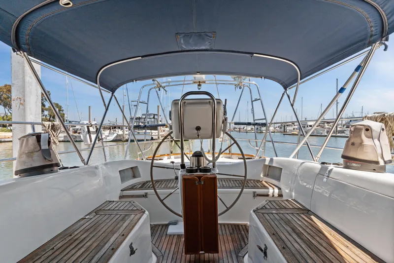Slide: The Image of Cockpit view of 2009 Pasport 51 sailboat docked at marina under blue canopy. - 9