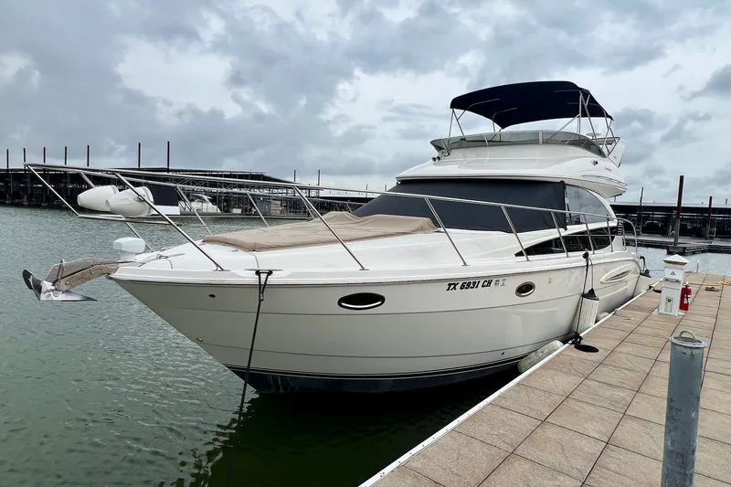 Slide: The Image of 2013 Meridian 391 Sedan yacht docked under cloudy skies. - 2