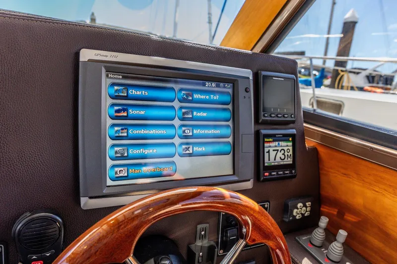 Slide: The Image of Helm of 2015 Cutwater 28 boat with navigation screens and controls. - 14