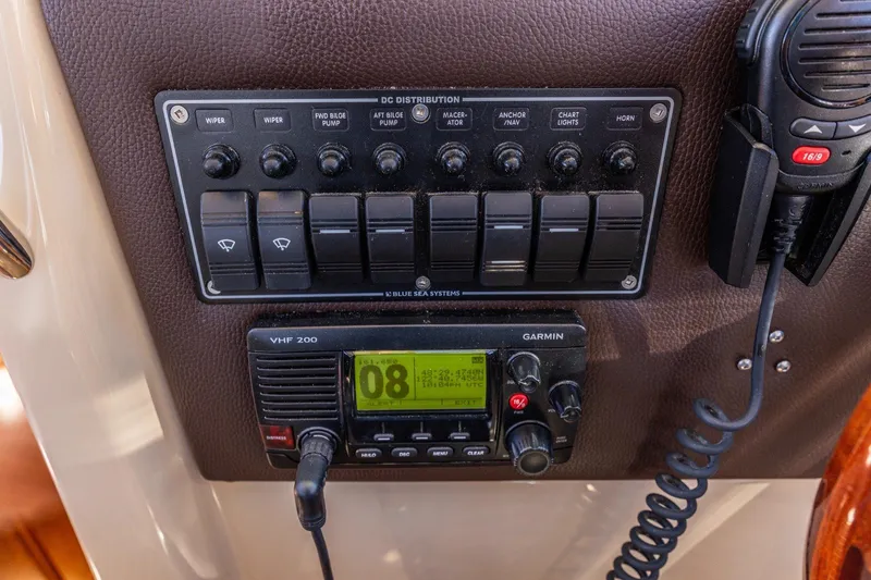 Slide: The Image of Control panel and VHF radio on a 2015 Cutwater 28 boat dashboard. - 15