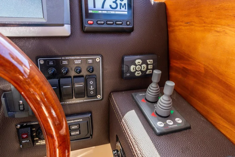 Slide: The Image of Control panel of a 2015 Cutwater 28 boat with joysticks and switches. - 16