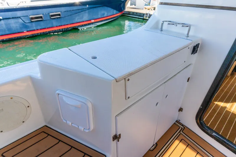 Slide: The Image of 2015 Cutwater 28 boat interior with white cabinetry and teak flooring. - 18