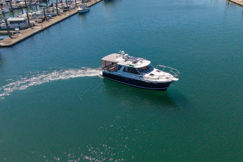 Slide: The Image of 2015 Cutwater 28 boat cruising in a marina, surrounded by calm blue water. - 3
