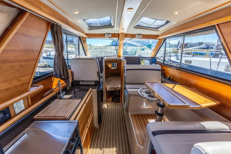 Slide: The Image of Interior of a 2015 Cutwater 28 boat with wood finishes and modern amenities. - 4