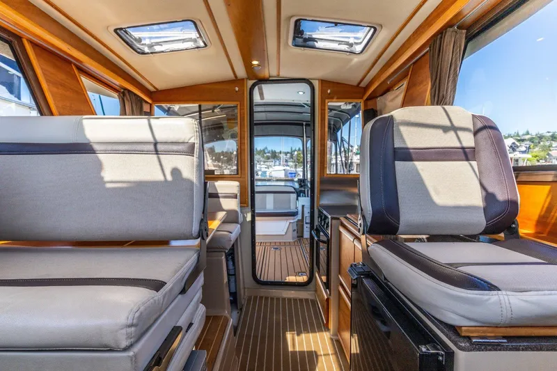 Slide: The Image of Interior of 2015 Cutwater 28 boat, featuring modern seating and wood accents. - 7