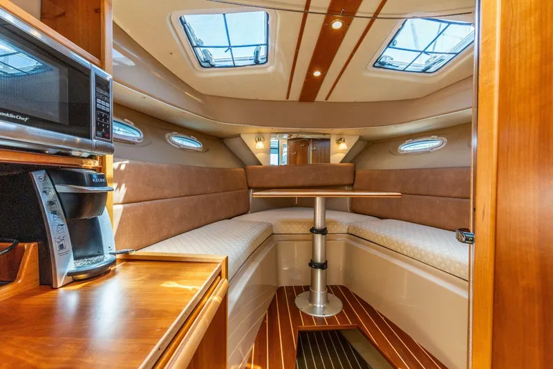 Slide: The Image of Interior of a 2015 Cutwater 28 boat with cozy seating and modern amenities. - 9