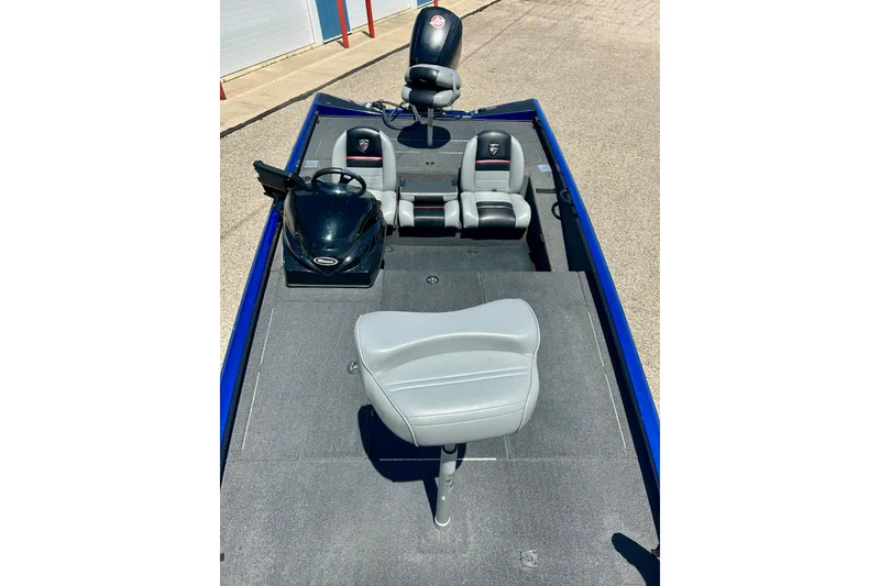 Slide: The Image of 2017 Triton 18 C TX boat interior with gray seating and steering console. - 14