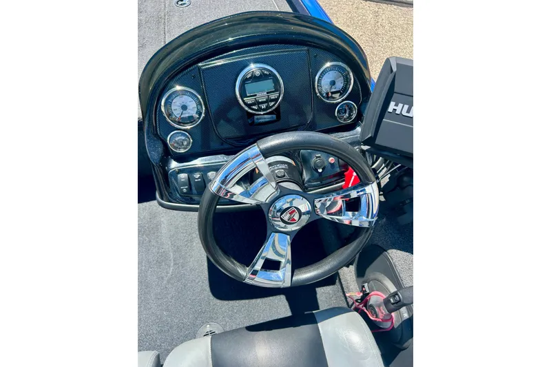 Slide: The Image of Steering console of a 2017 Triton 18 C TX boat with chrome accents and gauges. - 16