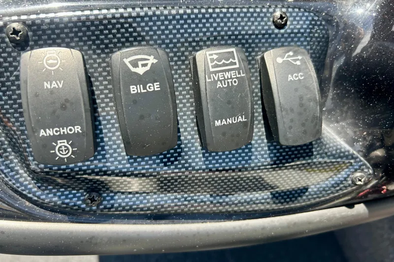 Slide: The Image of Control panel of a 2017 Triton 18 C TX boat with navigation switches. - 17
