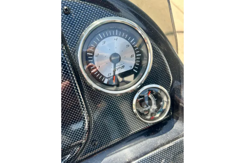 Slide: The Image of Dashboard of 2017 Triton 18 C TX boat with RPM and trim gauges. - 19