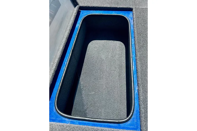 Slide: The Image of Storage compartment of 2017 Triton 18 C TX boat, featuring blue and gray interior. - 32