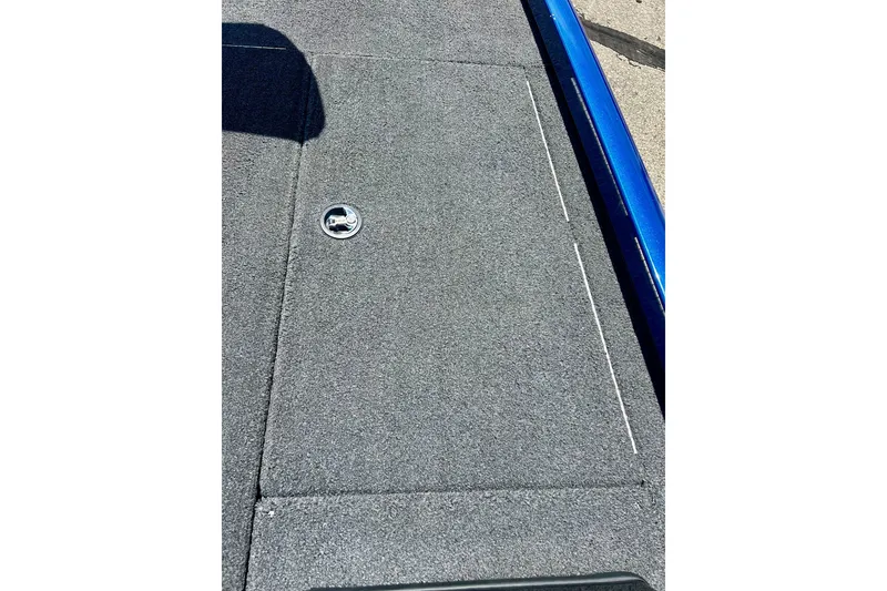 Slide: The Image of 2017 Triton 18 C TX boat deck with gray carpet and metal latch. - 33