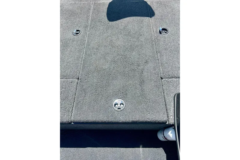 Slide: The Image of Carpeted deck of a 2017 Triton 18 C TX boat with storage compartments. - 35