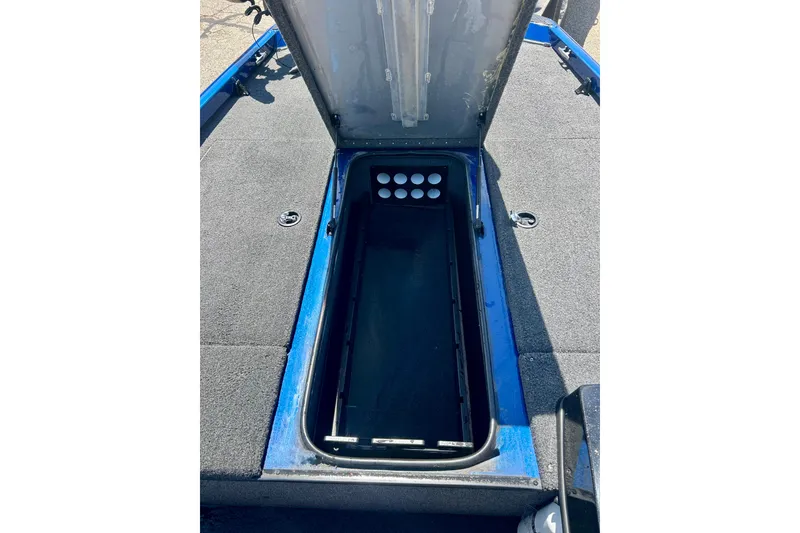 Slide: The Image of Open storage compartment on a 2017 Triton 18 C TX boat, featuring a spacious interior. - 36