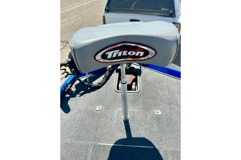 Slide: The Image of 2017 Triton 18 C TX boat seat with logo, on a sunny day. - 39
