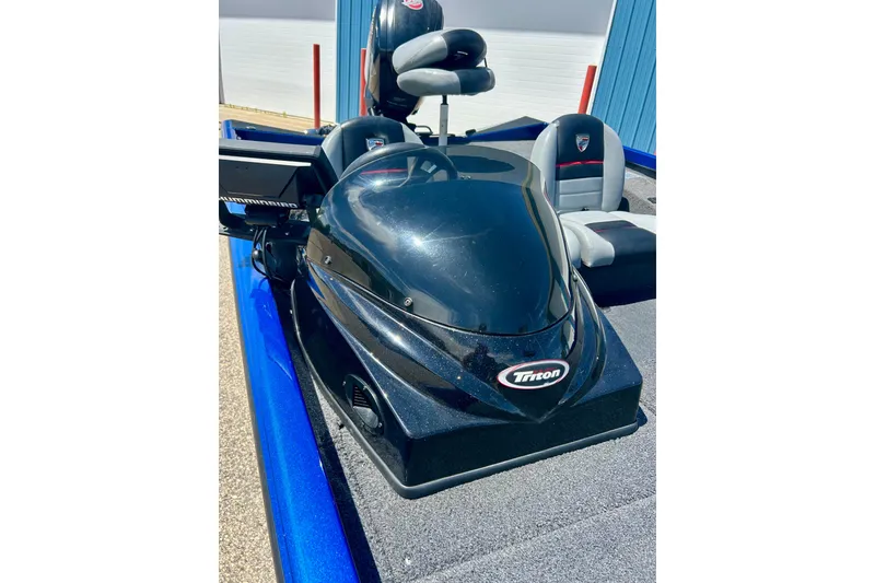 Slide: The Image of 2017 Triton 18 C TX boat interior with seats and control panel. - 42