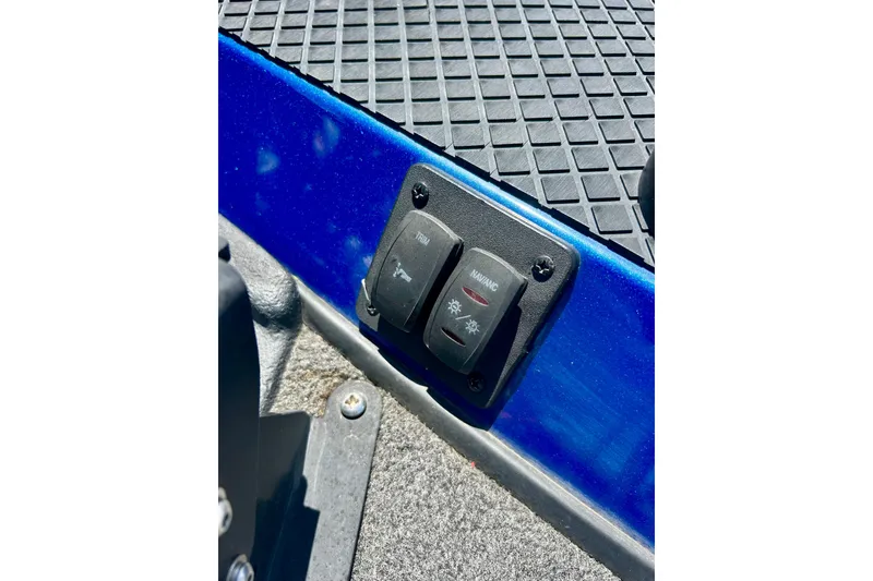 Slide: The Image of Control switches on a 2017 Triton 18 C TX boat dashboard, featuring trim and nav/ancillary functions. - 43