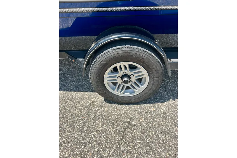 Slide: The Image of 2017 Triton 18 C TX trailer wheel on asphalt, showcasing tire and fender details. - 47