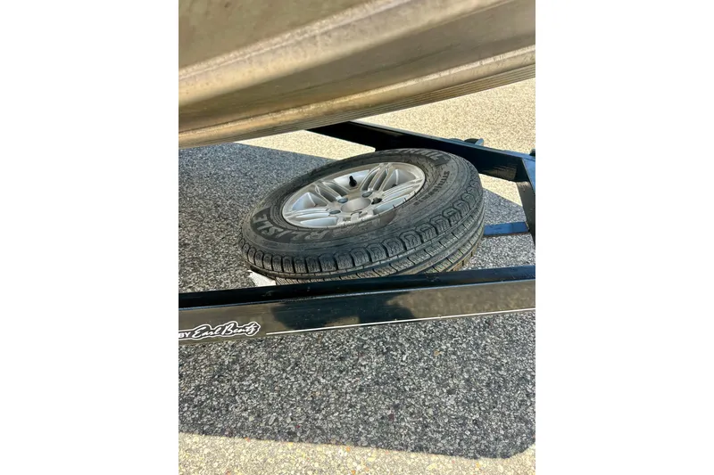 Slide: The Image of 2017 Triton 18 C TX trailer with spare tire on asphalt surface. - 48