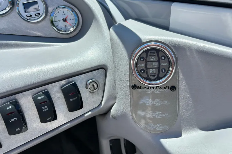 Slide: The Image of Dashboard controls of a 2002 MasterCraft ProStar 197 boat, featuring gauges and switches. - 14