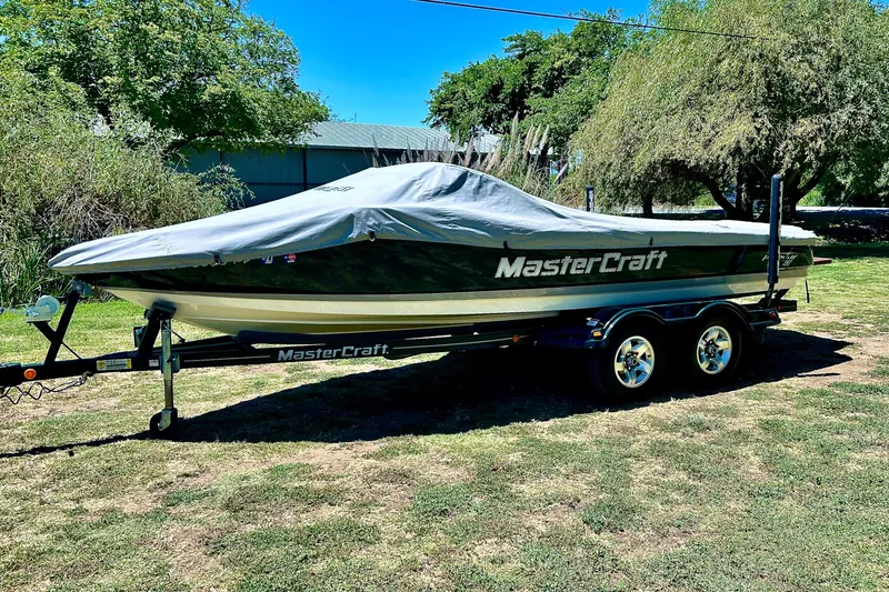 Slide: The Image of Covered 2002 MasterCraft ProStar 197 boat on trailer, parked outdoors. - 17
