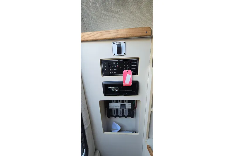 Slide: The Image of Control panel of a 1999 Four Winns 258 Vista boat, featuring switches and indicators. - 13
