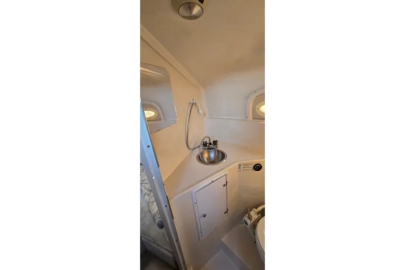 Slide: The Image of 1999 Four Winns 258 Vista boat bathroom with sink and mirror. - 18