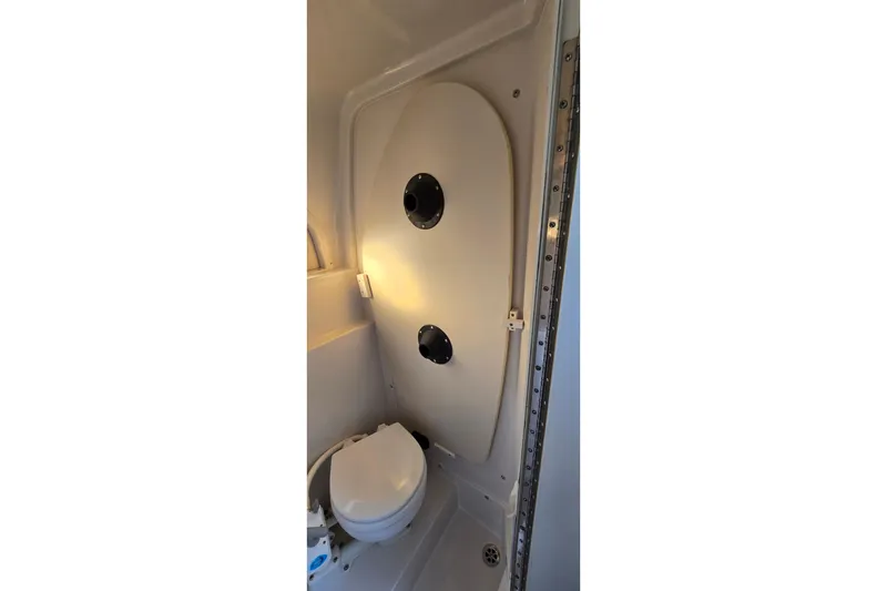 Slide: The Image of 1999 Four Winns 258 Vista boat bathroom interior with toilet and shower. - 19