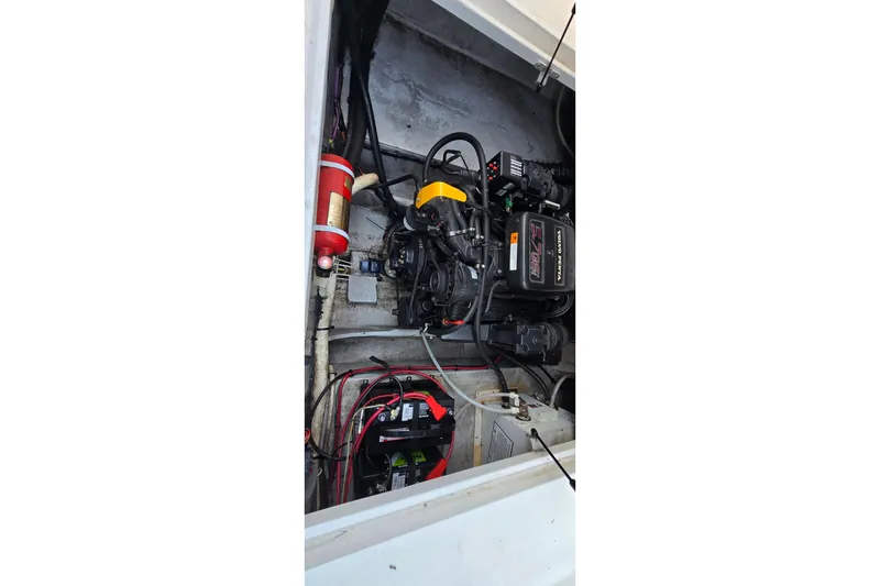 Slide: The Image of 1999 Four Winns 258 Vista engine compartment with visible wiring and components. - 22