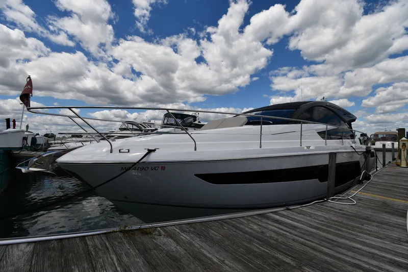 The Image of 2024 Fairline G50 Targa yacht docked under a partly cloudy sky. - 1