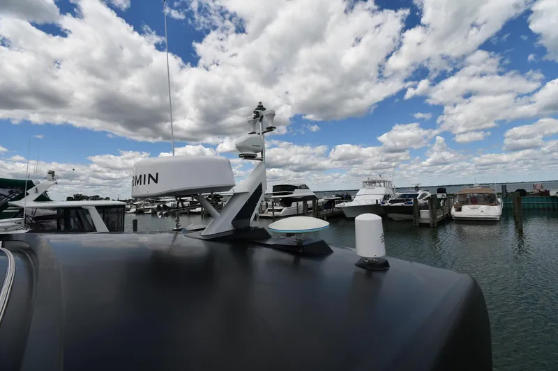 Slide: The Image of 2024 Fairline G50 Targa yacht docked at marina under cloudy sky. - 10